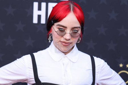 Photo for Billie Eilish wearing Thom Browne with Oliver Peoples glasses arrives at the 29th Annual Critics' Choice Awards held at The Barker Hangar on January 14, 2024 in Santa Monica, Los Angeles, California, United States. - Royalty Free Image