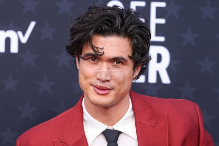 Photo for Charles Melton wearing a Valentino suit and shoes, Maria Tash earrings and an Omega watch arrives at the 29th Annual Critics' Choice Awards held at The Barker Hangar on January 14, 2024 in Santa Monica, Los Angeles, California, United States. - Royalty Free Image