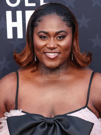 Photo for Danielle Brooks wearing Norman Silverman earings, a Monsoori dress, and Graziela rings and bracelets arrives at the 29th Annual Critics' Choice Awards held at The Barker Hangar on January 14, 2024 in Santa Monica, Los Angeles, California, USA - Royalty Free Image