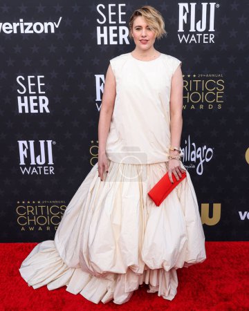 Photo for Greta Gerwig wearing a Molly Goddard dress, Tabayer jewelry and Jimmy Choo shoes arrives at the 29th Annual Critics' Choice Awards held at The Barker Hangar on January 14, 2024 in Santa Monica, Los Angeles, California, United States. - Royalty Free Image