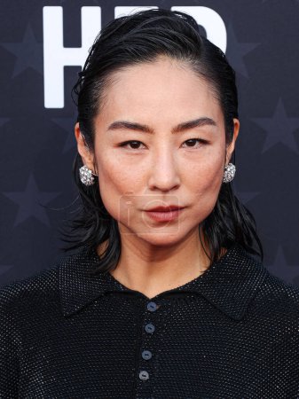 Photo for Greta Lee wearing a Loewe dress and Tiffany and Co. jewelry arrives at the 29th Annual Critics' Choice Awards held at The Barker Hangar on January 14, 2024 in Santa Monica, Los Angeles, California, United States. - Royalty Free Image