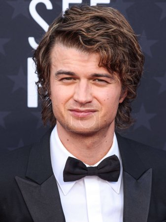 Photo for Joe Keery wearing Louis Vuitton arrives at the 29th Annual Critics' Choice Awards held at The Barker Hangar on January 14, 2024 in Santa Monica, Los Angeles, California, United States. - Royalty Free Image