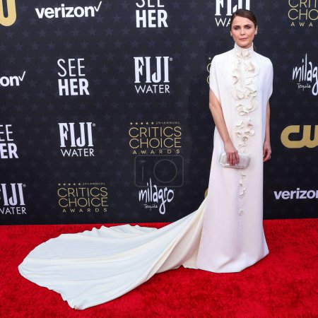 Photo for Keri Russell wearing a Stephane Rolland dress, Christian Louboutin shoes, a Tyler Ellis bag, and Fernango Jorge jewelry arrives at the 29th Annual Critics' Choice Awards held at The Barker Hangar on January 14, 2024 in Santa Monica, Los Angeles, USA - Royalty Free Image