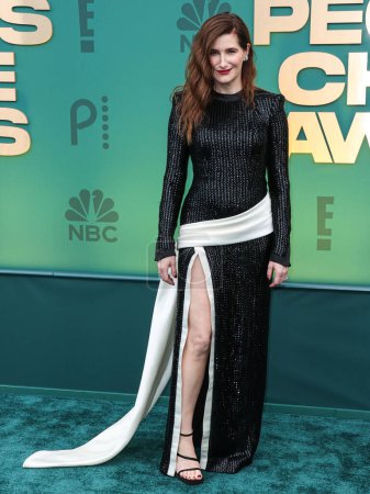 Photo for Kathryn Hahn wearing a Ronald van der Kemp dress with Roger Vivier shoes arrives at the 49th Annual People's Choice Awards 2024 held at The Barker Hangar on February 18, 2024 in Santa Monica, Los Angeles, California, United States. - Royalty Free Image