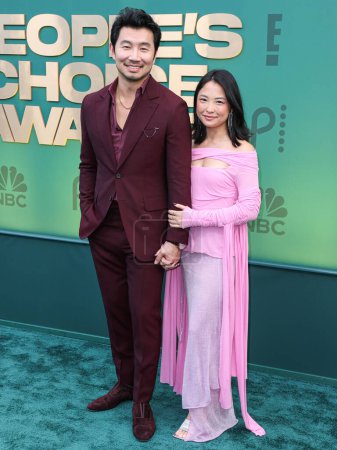 Photo for Simu Liu and girlfriend Allison Hsu arrive at the 49th Annual People's Choice Awards 2024 held at The Barker Hangar on February 18, 2024 in Santa Monica, Los Angeles, California, United States. - Royalty Free Image