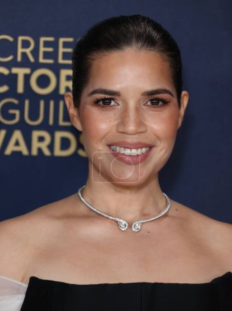 Photo for America Ferrera wearing a Dior dress, Stewart Weitzman shoes, Debeers jewelry and carring a Tyler Ellis clutch arrives at the 30th Annual Screen Actors Guild Awards held at the Shrine Auditorium and Expo Hall on February 24, 2024 in Los Angeles - Royalty Free Image