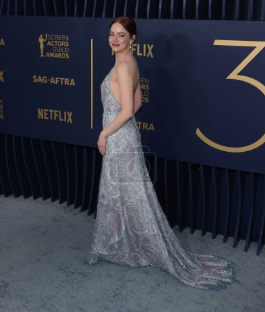 Photo for Emma Stone wearing a Louis Vuitton metallic lace slip gown, embroidered with sequins, pearls and crystals fern leaf pattern and ivory sandals with Louis Vuitton High Jewelry arrives at the 30th Annual Screen Actors Guild Awards held - Royalty Free Image