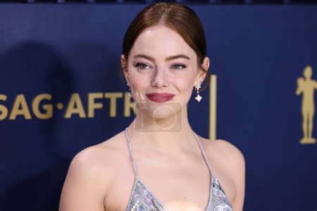 Photo for Emma Stone wearing a Louis Vuitton metallic lace slip gown, embroidered with sequins, pearls and crystals fern leaf pattern and ivory sandals with Louis Vuitton High Jewelry arrives at the 30th Annual Screen Actors Guild Awards held - Royalty Free Image