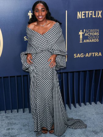 Photo for Ayo Edebiri wearing a Luar look with Tabayer jewelry arrives at the 30th Annual Screen Actors Guild Awards held at the Shrine Auditorium and Expo Hall on February 24, 2024 in Los Angeles, California, United States. - Royalty Free Image
