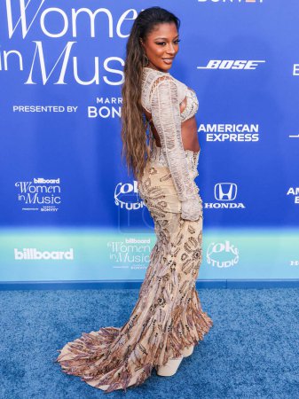 Photo for Victoria Monet wearing Dodone Avdiu arrives at the 2024 Billboard Women In Music held at the YouTube Theater at SoFi Stadium on March 6, 2024 in Inglewood, Los Angeles, California, United States. - Royalty Free Image