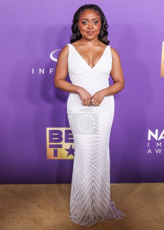 Photo for Quinta Brunson wearing a Naeem Kahn dress with Walter Faith jewels and Jimmy Choo shoes arrives at the 55th Annual NAACP Image Awards held at the Shrine Auditorium and Expo Hall on March 16, 2024 in Los Angeles, California, United States. - Royalty Free Image
