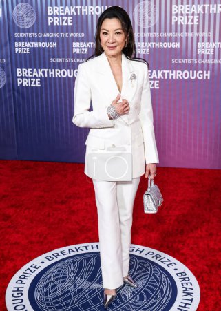 Photo for Michelle Yeoh wearing Tom Ford and carrying Balenciaga arrives at the 10th Annual Breakthrough Prize Ceremony held at the Academy Museum of Motion Pictures on April 13, 2024 in Los Angeles, California, United States. - Royalty Free Image