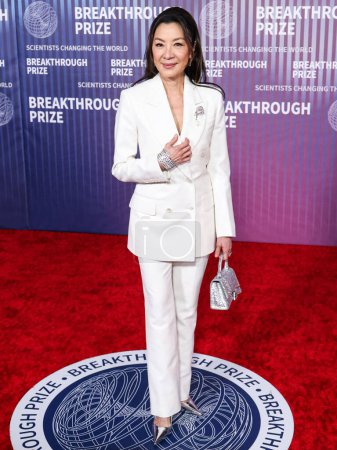 Photo for Michelle Yeoh wearing Tom Ford and carrying Balenciaga arrives at the 10th Annual Breakthrough Prize Ceremony held at the Academy Museum of Motion Pictures on April 13, 2024 in Los Angeles, California, United States. - Royalty Free Image