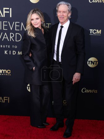 Photo for Michelle Pfeiffer and husband David E. Kelley arrive at the 49th Annual AFI (American Film Institute) Lifetime Achievement Award Gala Tribute Celebrating Nicole Kidman held at the Dolby Theatre on April 27, 2024 in Hollywood, Los Angeles, California - Royalty Free Image