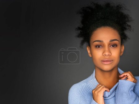 Photo for Close up portrait of a 30 year old pensive african american woman lookingat camera - psychology and womens health concept. Photo on a dark grey background. - Royalty Free Image