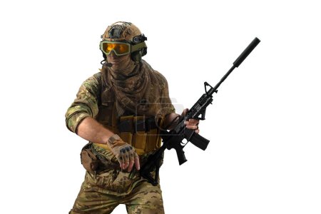 Mercenary soldier in camouflage clothes walks with an automatic rifle in his hand and looks away. A professional special forces soldier during a special operation. Photo isolated on white background.