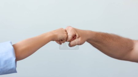 Photo for Close-up of a couples hands with fists clenched in opposition, representing relationship tension and lack of compromise. - Royalty Free Image
