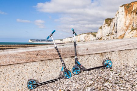 Photo for Two scooters parked in front of the white coast of etretat france at sunset - travel concept - Royalty Free Image