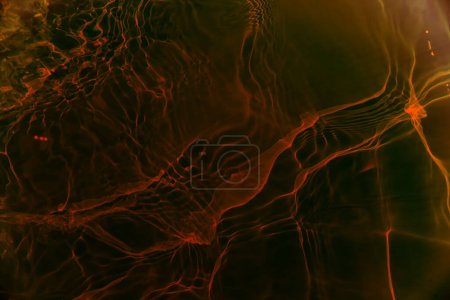 Photo for Defocus blurred transparent orange colored clear calm water surface texture with splashes and bubbles. Trendy abstract nature background. Water waves in sunlight with copy space. Red watercolor shine - Royalty Free Image
