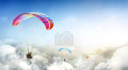 Photo for Paragliding multicolor. Paraglider flying over Landscape from the background Beauty nature mountain landscape of the sky. Paragliding Sports. Concept of extreme sport, taking adventure challenge. - Royalty Free Image