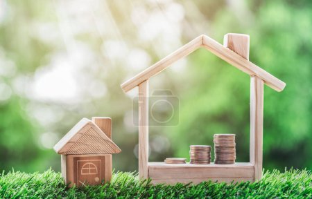 Photo for Coins placed is a staircase in a model house and a house on the grass. planning savings money of coins to buy a home concept for property, mortgage and real estate investment, savings for a house. - Royalty Free Image