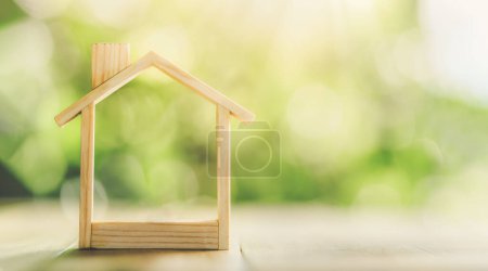 Photo for Wooden model house place on the table. concept of real estate investment. planning savings money of coins to buy a home concept for property, mortgage and real estate investment, savings for a house. - Royalty Free Image