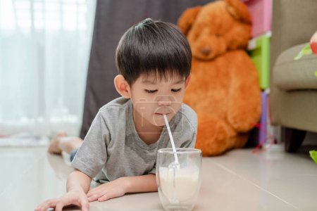 Photo for Asian boy is drinking a glass of milk - Royalty Free Image