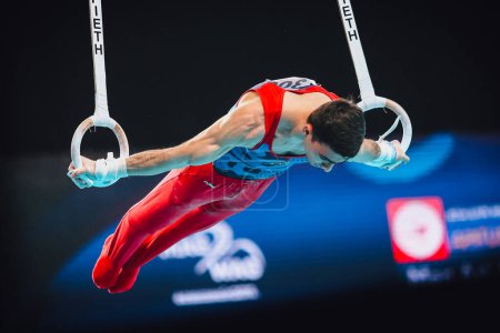 Photo for Szczecin, Poland, April 10, 2019:Tovmasyan Artur of Armenia competes on the rings during the European artistic gymnastics championships at the Netto Arena - Royalty Free Image