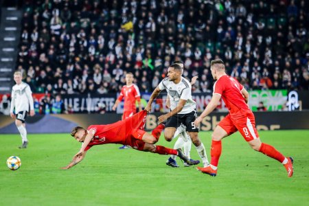 Photo for Wolfsburg, Germany, March 20, 2019: footballers Jonathan Tah (GER) and Sergej Milinkovic (SRB) in action during the international soccer game Germany vs Serbia in Wolfsburg - Royalty Free Image