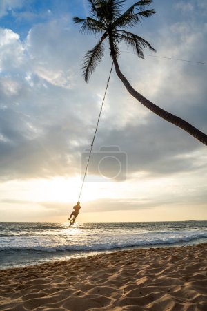 Photo for Palm tree swing above ocean at Dalawella Beach, Unawatuna, Sri Lanka,. High quality photo - Royalty Free Image