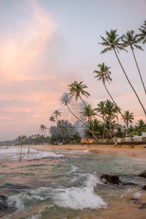 Photo for Sunrise with fishermen in Unawatuna, Sri Lanka, beach, palm trees and ocean. High quality photo - Royalty Free Image