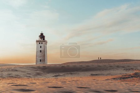 Photo for Minimalistic photo of people at sunset Rubjerg Knude Lighthouse Denmark. High quality photo - Royalty Free Image