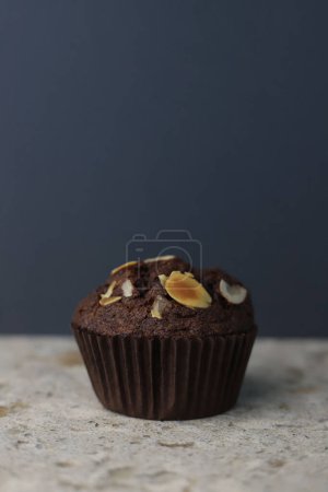 fragrant homemadechocolate cupcake with walnuts on a light background. for banners, postcards, napkins, flyers, business cards, screensavers, labels, etc.