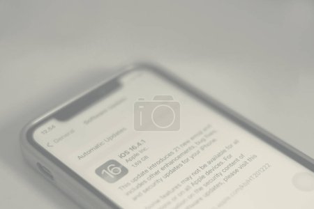 Photo for Macro image of the update to iOS 16.4.1 on a smartphone screen - Royalty Free Image