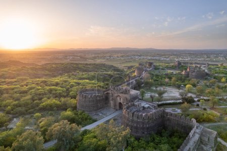 Beautiful landscape of Rohtas fort on top of green hills during sunset. Ruins of old vintage castle. which shows ancient Indian history, heritage and architecture.