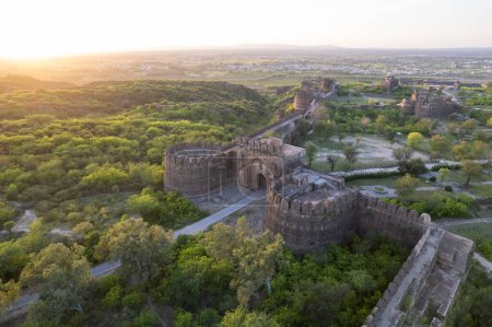 Beautiful landscape of Rohtas fort on top of green hills during sunset. Ruins of old, ancient, historical, vintage Indian/Pakistani castle.