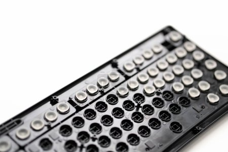Photo for Repair, cleaning the keyboard. disassembled black keyboard, rubber white keyboard caps. - Royalty Free Image