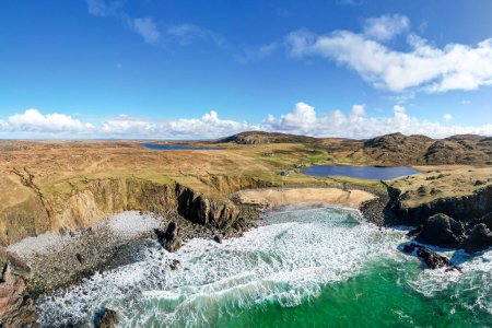 Aerial view of beautiful Dailbeag beach, Isle of Lewis. A remote, deserted Scottish beach in the Outer Hebrides. Blue sky and turquoise water in this coastal location. 
