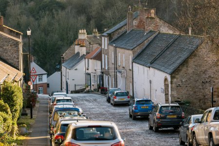 Photo for 9th January 2022. Richmond, UK. Quiet street in Richmond, North Yorkshire, with residential houses and no people on a sunny day. - Royalty Free Image