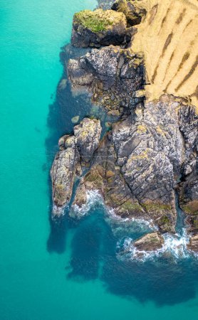Aerial drone view of Port of Stoth on the Isle of Lewis. Turquoise water surrounded by outcrops and cliffs of surrounding cove in Outer Hebrides