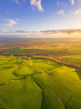Aerial vertical view of Baildon Moor in Yorkshire countryside near Leeds. Sunset landscape with green fields.