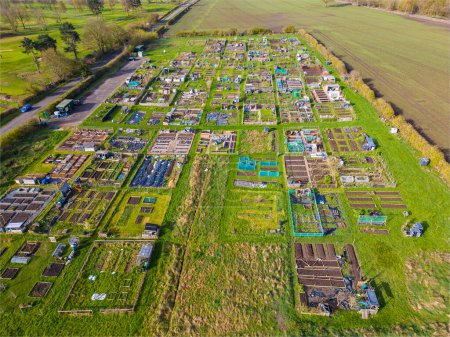 Aerial view of vegetable allotments forming geometric pattern in spring weather. Alwoodley Allotments in Leeds, West Yorkshire, viewed from above. 
