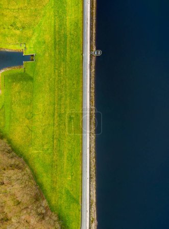 Aerial vertical view of Fewston Reservoir, North Yorkshire, and road running over the dam.