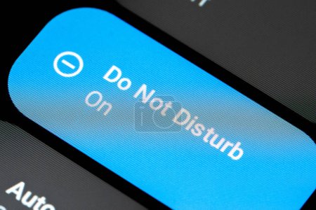 Foto de Close-up of a smartphone device screen showing the DND Do not Disturb mode being enabled - Imagen libre de derechos