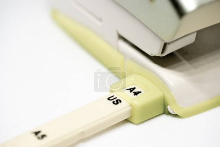 Photo for Close-up of a hole puncher for paper sheets of size DIN A4 on white background - Royalty Free Image