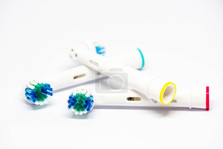 Photo for Three interchangeable heads for one electric toothbrush isolated on white background - Royalty Free Image