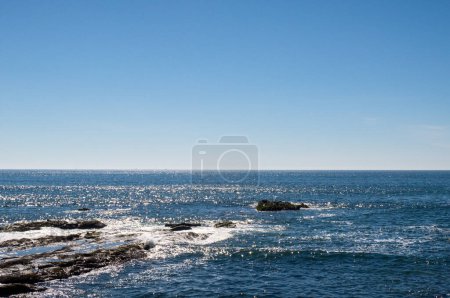 Foto de Un mar azul con costa rocosa - Imagen libre de derechos