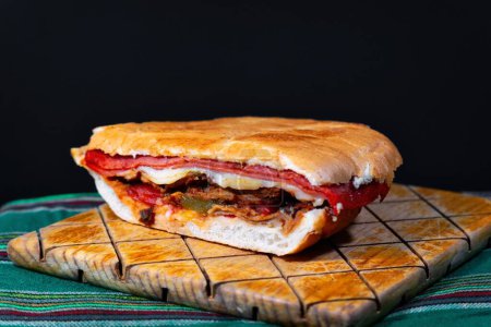 Photo for A Mexican Torta Caprichosa Grande with Milanese pork, leg ham and cheese - Royalty Free Image