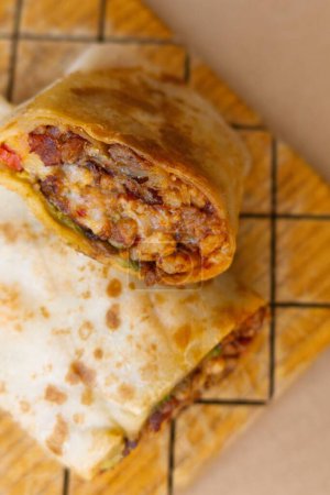 Photo for A Pastor mexican burrito with meat and hot sauce - Royalty Free Image