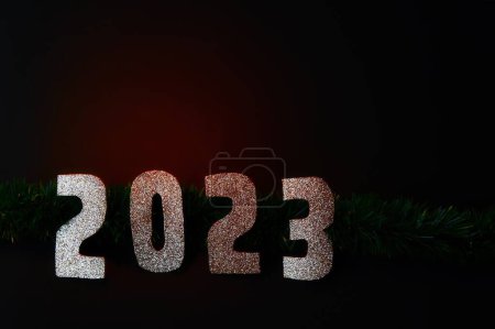 Photo for A Happy New Year 2023. Golden numbers on a black background with glitter - Royalty Free Image